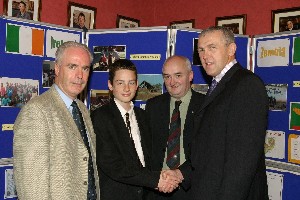 Guest Speaker at the Abbey Christian Brothers' Grammar School Achievement Prizegiving Ceremony, Dr. Eugene Young congratulates Jonathan Rafferty, Captain of the Nannery Cup football team. Also Included is  Mr. Dermot McGovern, Headmaster and Mr. Sean Og McAteer, Board of Governors.